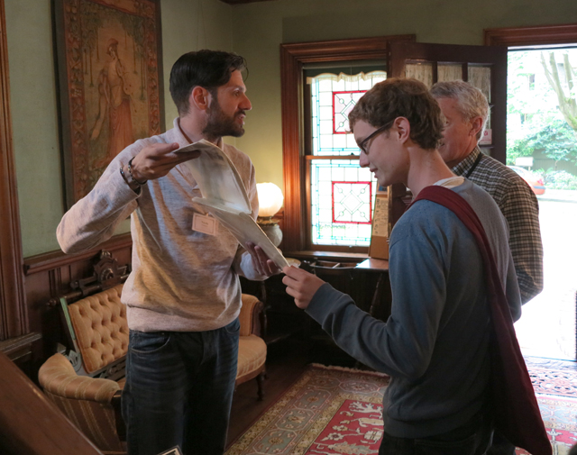 Man showing a map to guests in the entrance of the museum.